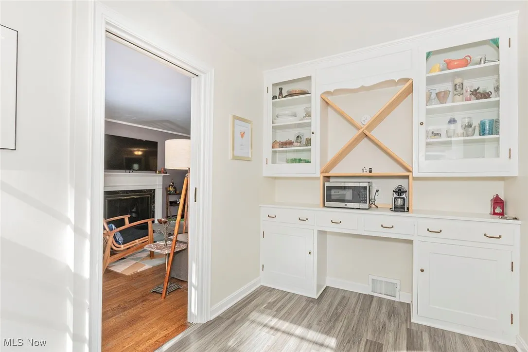 Kitchen with light wood-style flooring, and built in study area