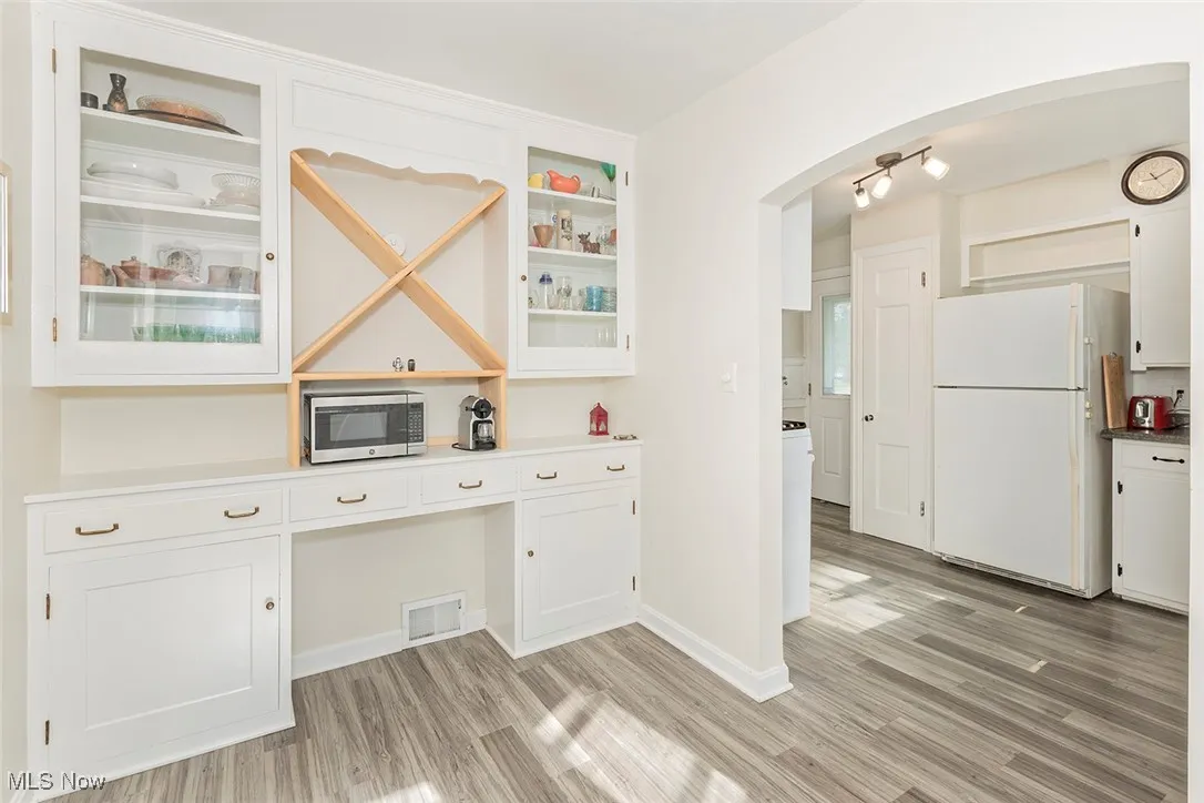 Kitchen space with light wood-style floors, and built in area