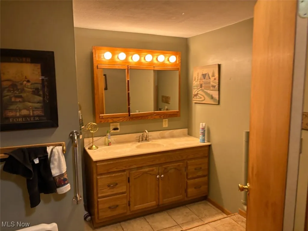 Bathroom with vanity and tile patterned flooring