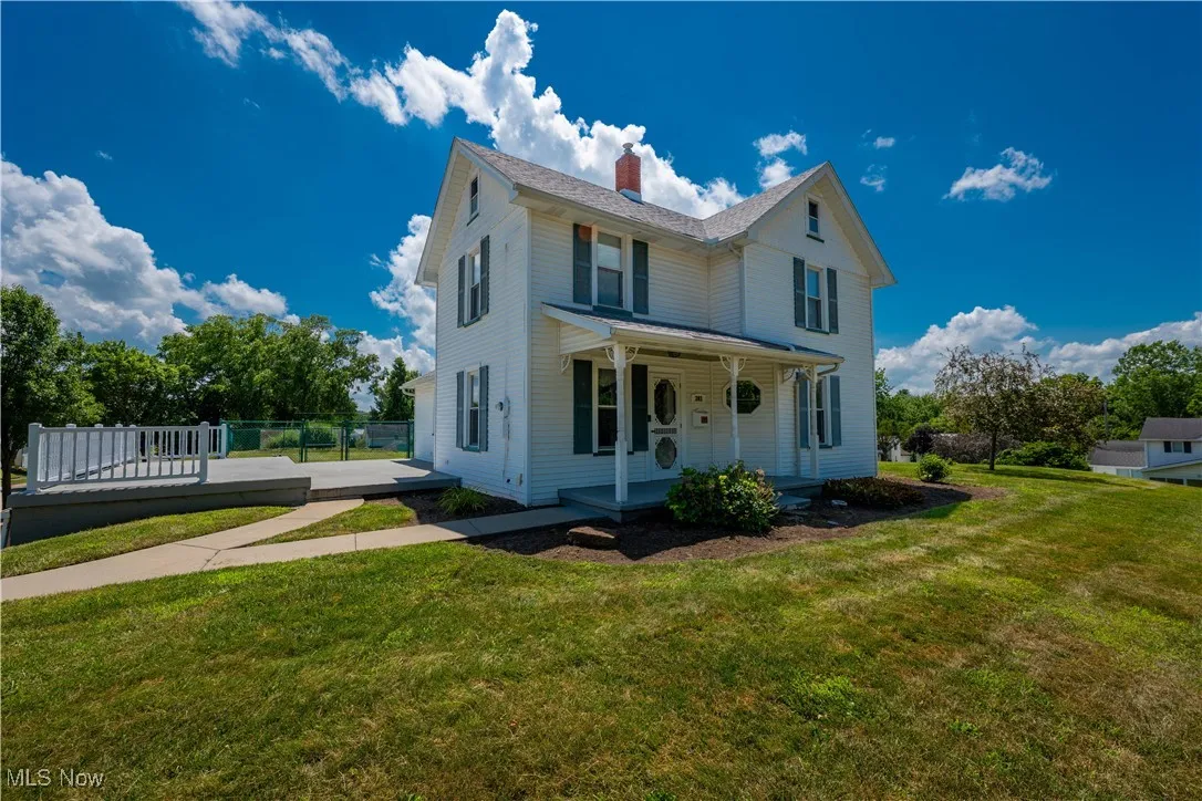 Historic home with charming front porch and large side patio