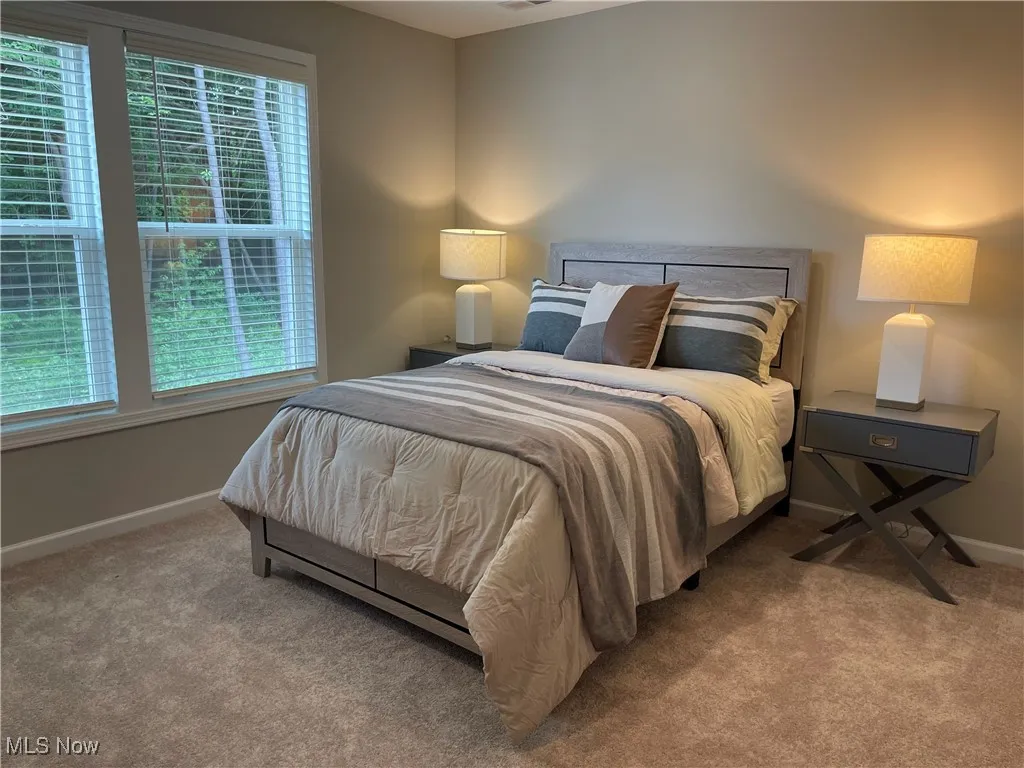main floor owner's suite with large windows overlooking the private back yard.