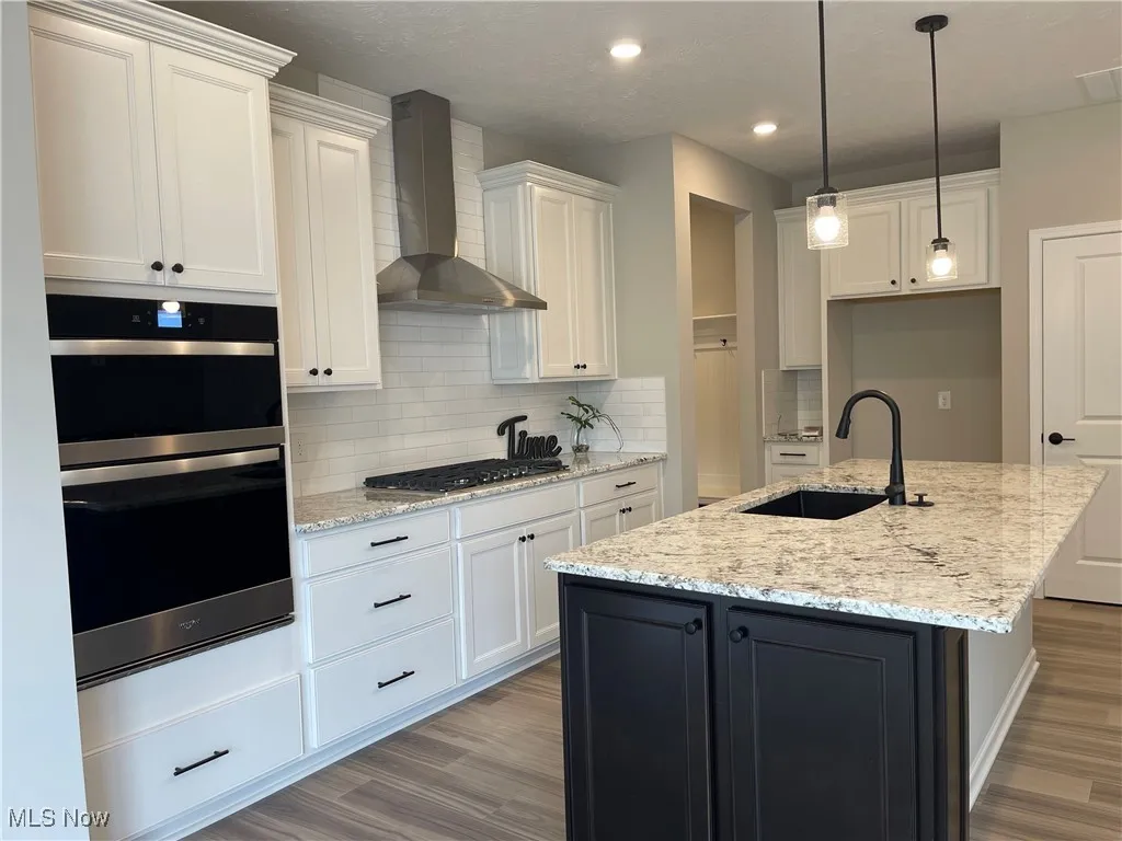 Upgraded maple cabinetry throughout kitchen, with built-in stainless appliances