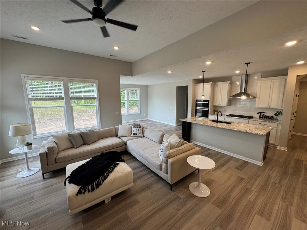 Numerous large windows blanket the living space in natural light.