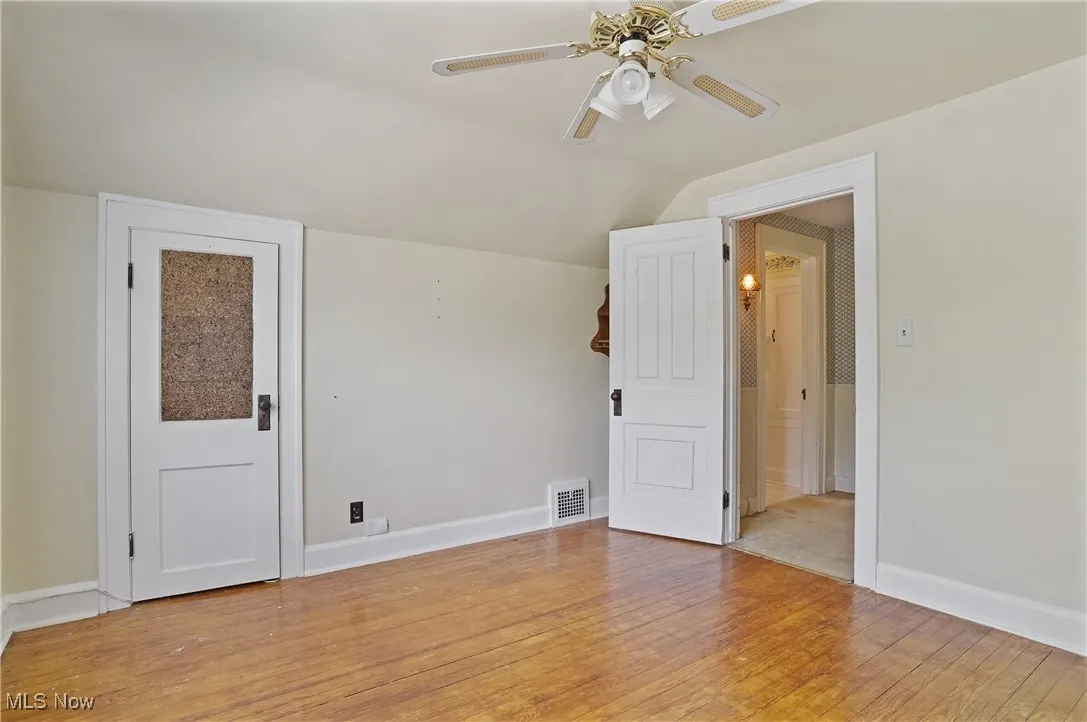 Additional living space with a ceiling fan, vaulted ceiling, and light wood-style flooring