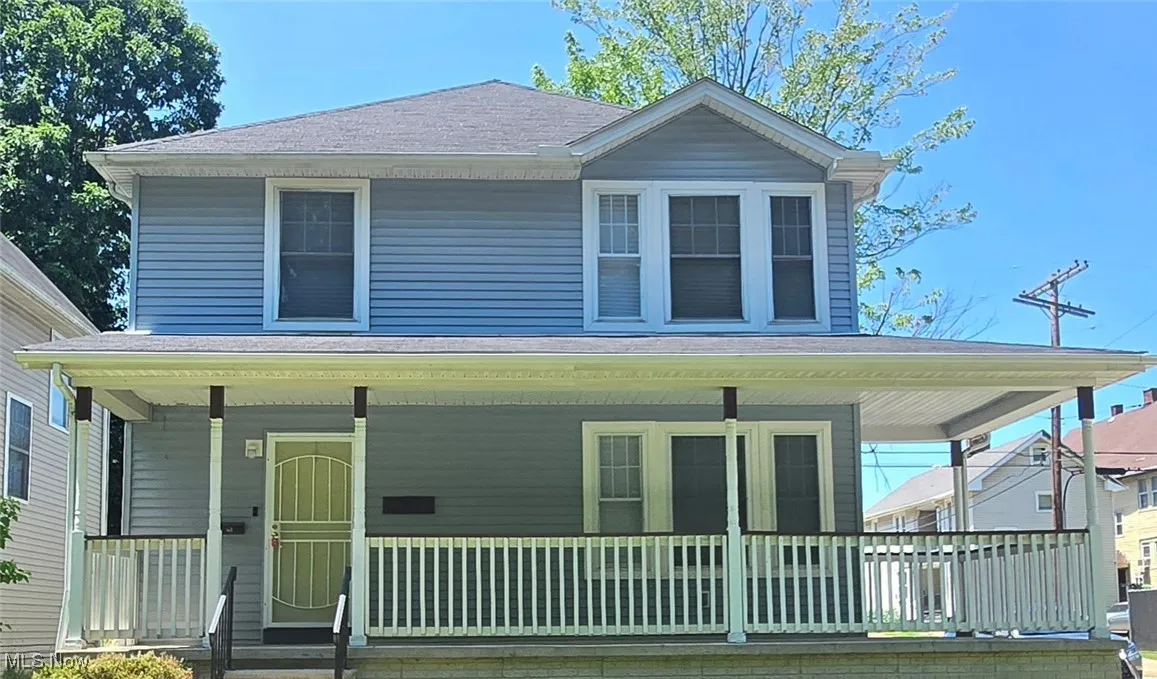 View of front of house with a porch and a shingled roof
