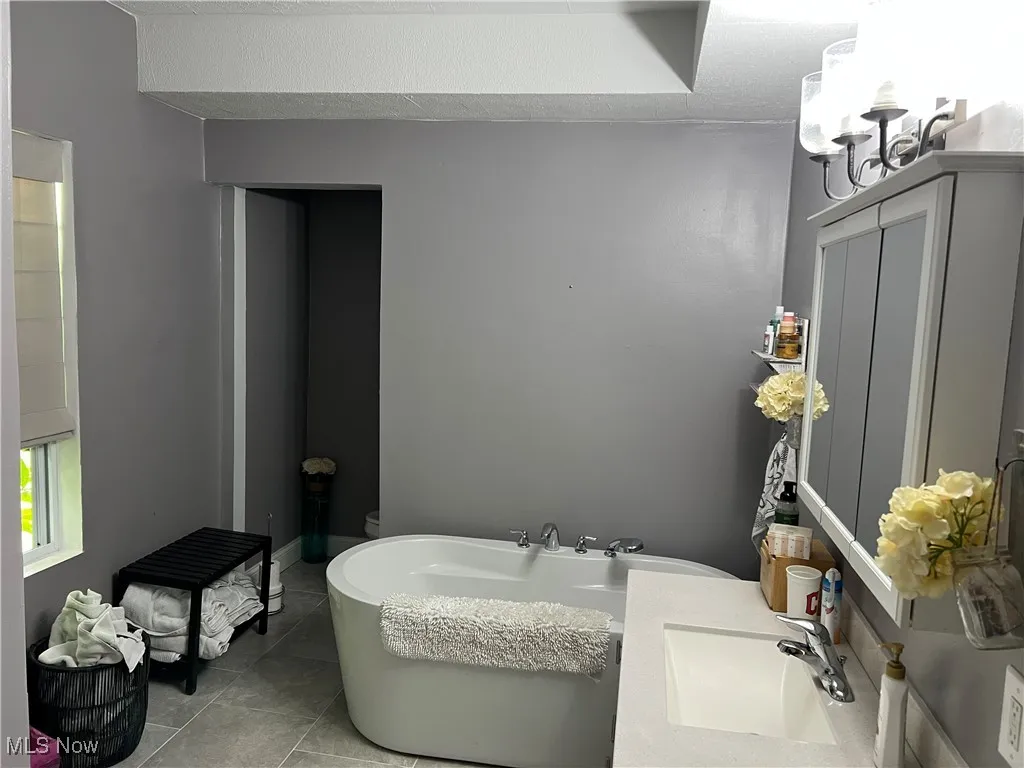 Bathroom featuring a freestanding tub, and vanity