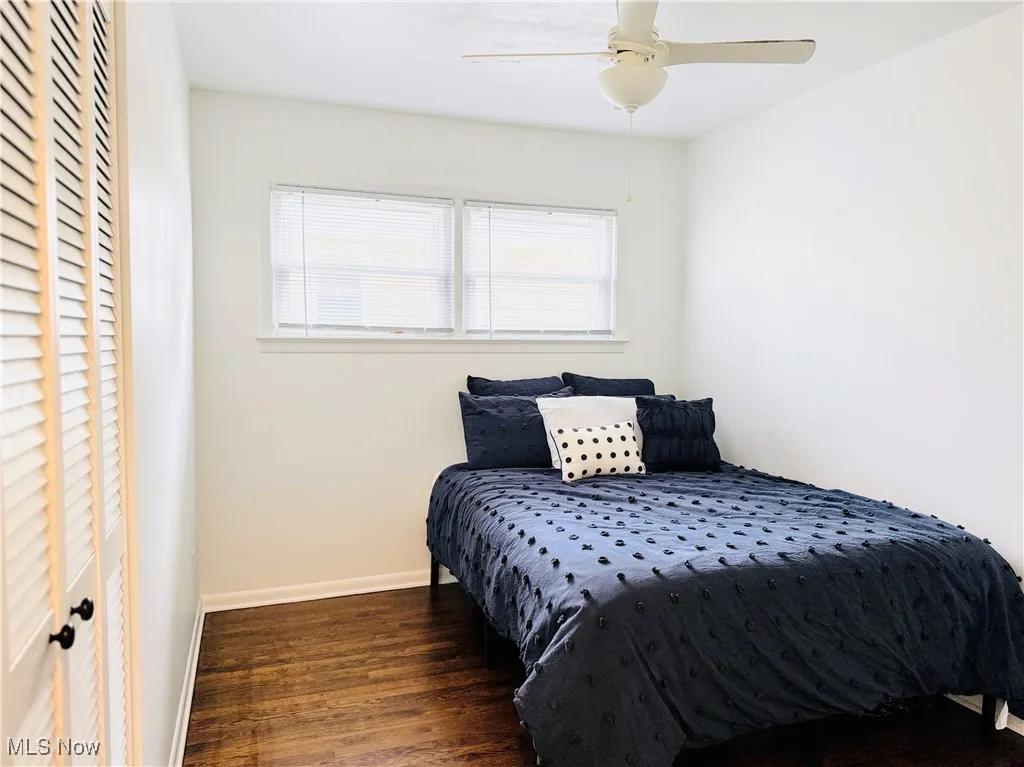 Bedroom featuring wood finished floors and a ceiling fan