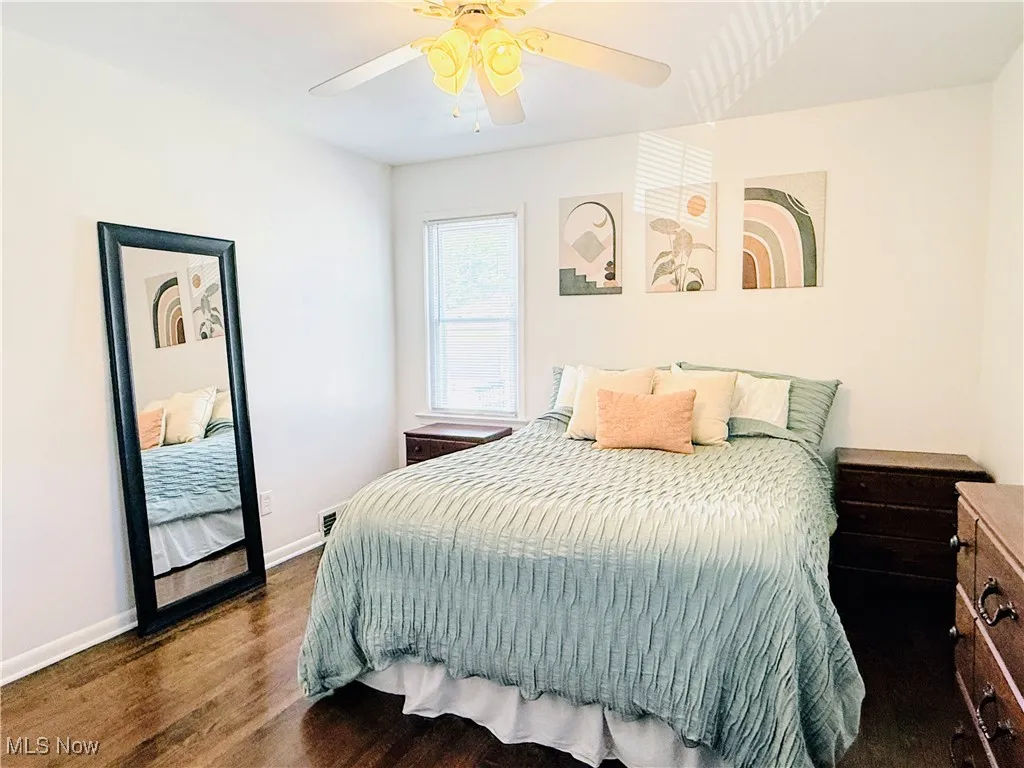 Bedroom featuring wood finished floors and ceiling fan