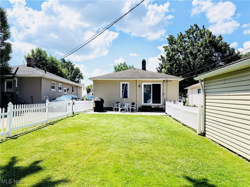 Back of house with a chimney, a patio area, and a fenced backyard