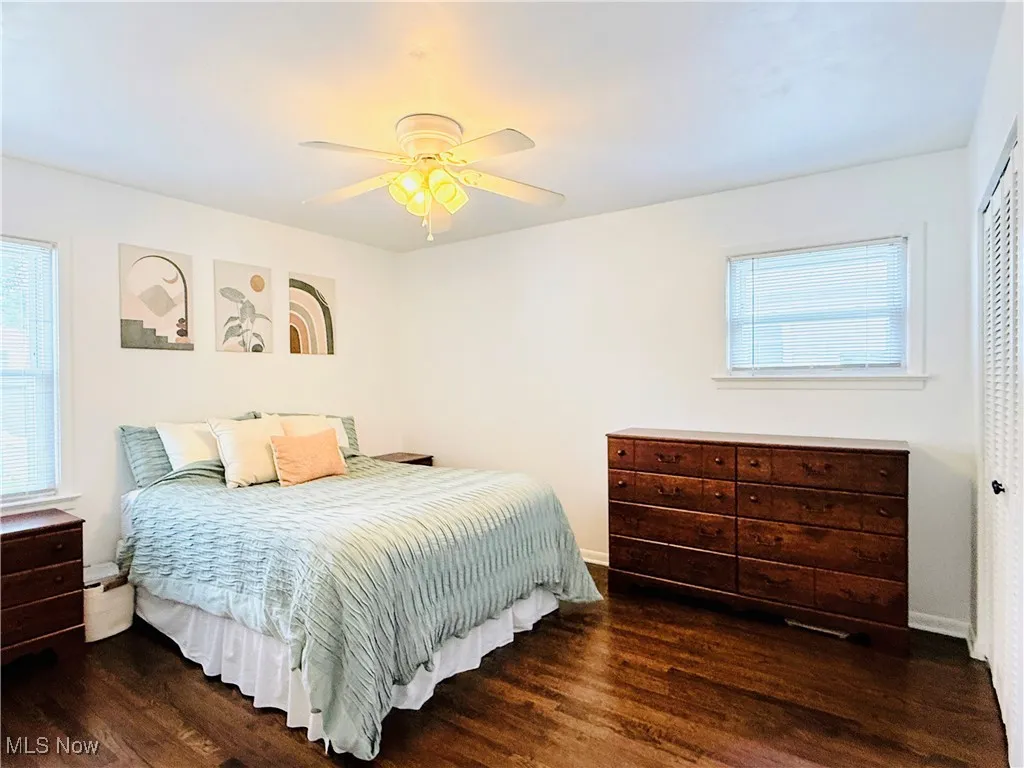 Bedroom with wood finished floors, a closet, and a ceiling fan