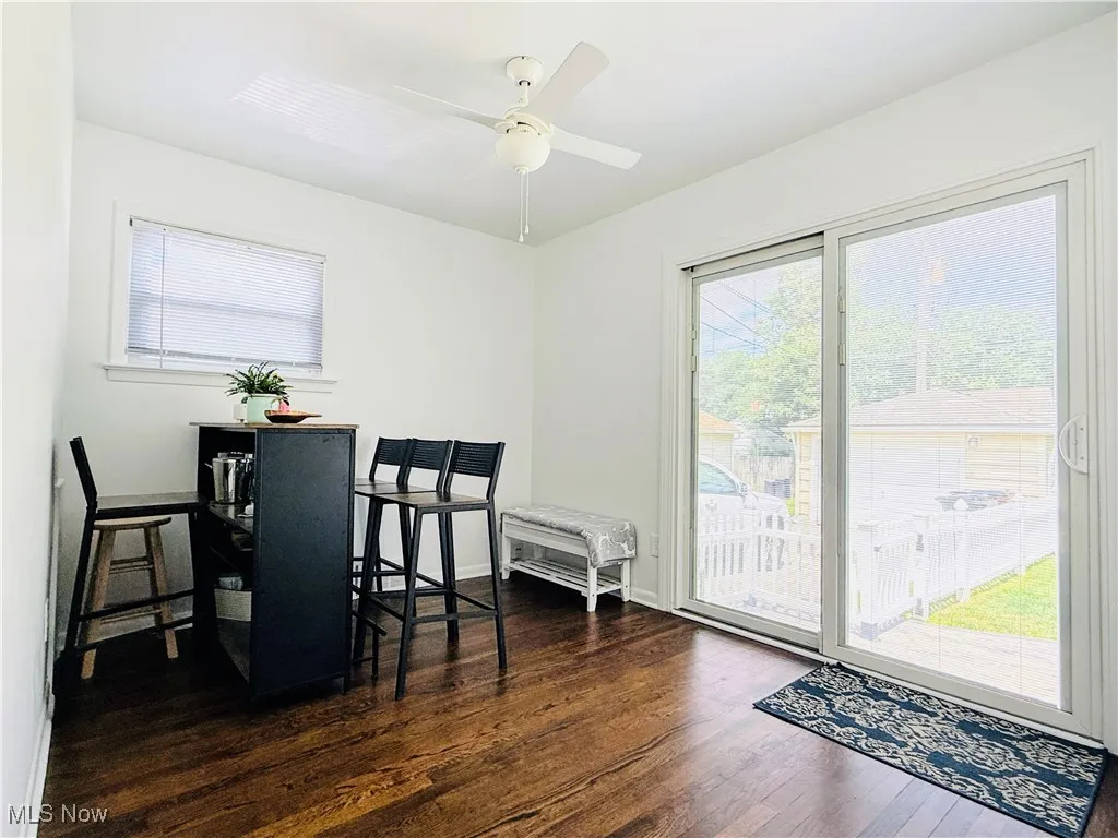 Dining room with wood finished floors and ceiling fan