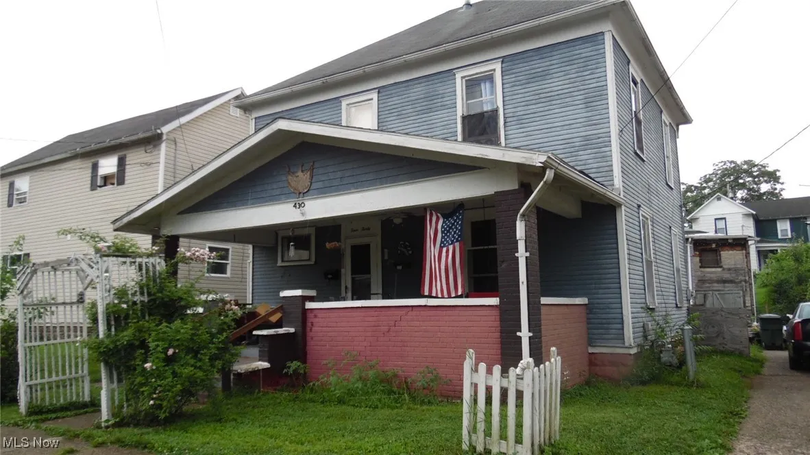 View of front of home with covered porch and brick siding