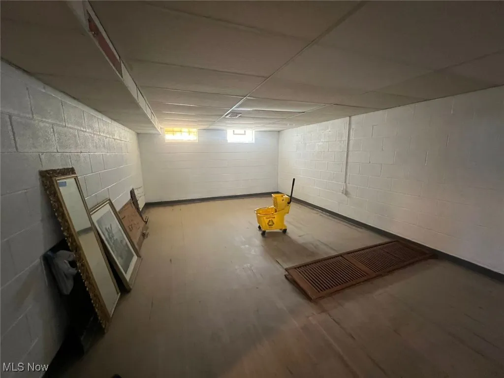 Basement featuring wood finished floors and a drop ceiling
