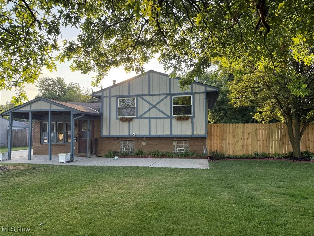 Rear view of house featuring a patio area and brick siding