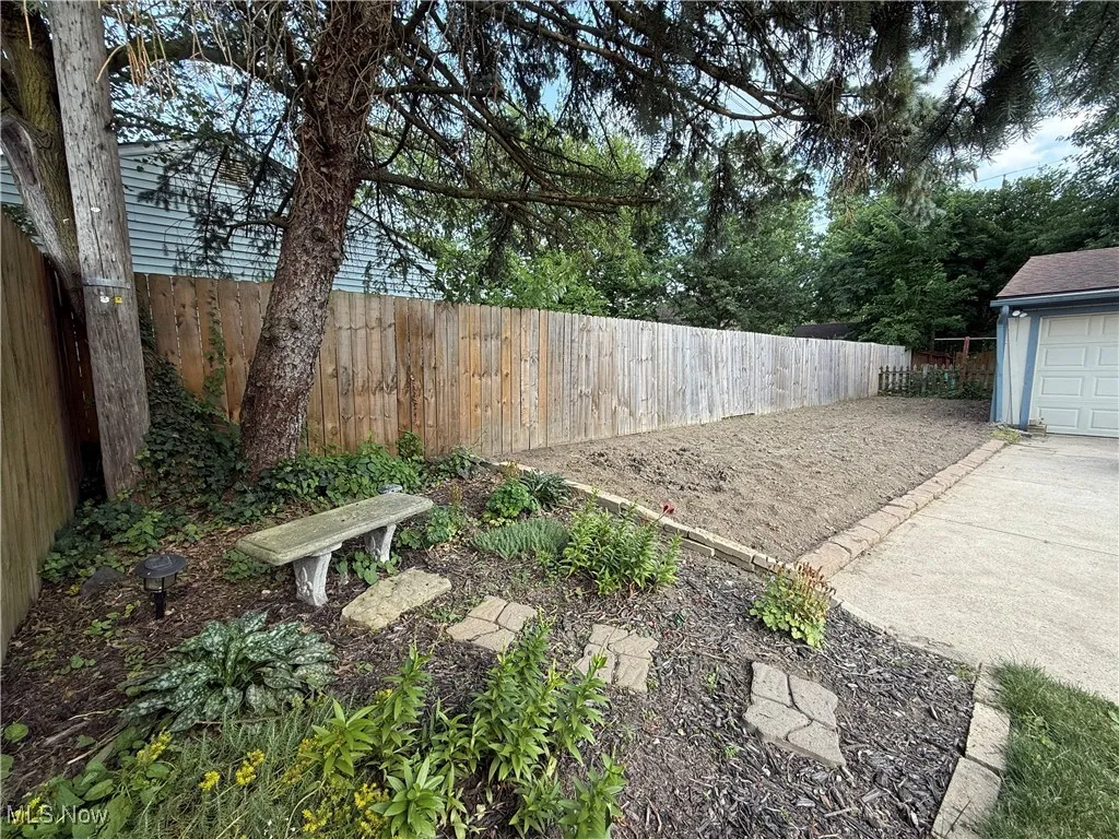 View of yard featuring concrete driveway