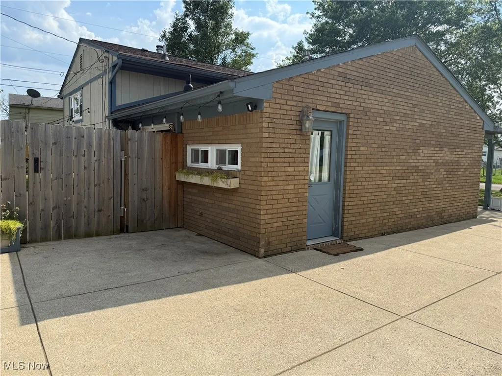 View of property exterior featuring brick siding