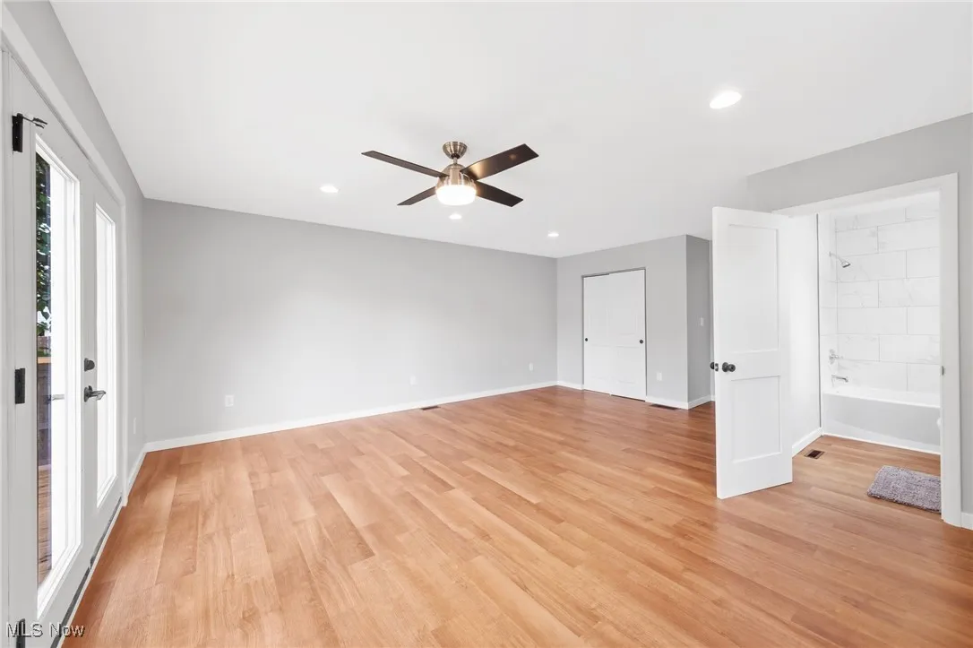 Empty room featuring ceiling fan, light wood-style floors, and recessed lighting