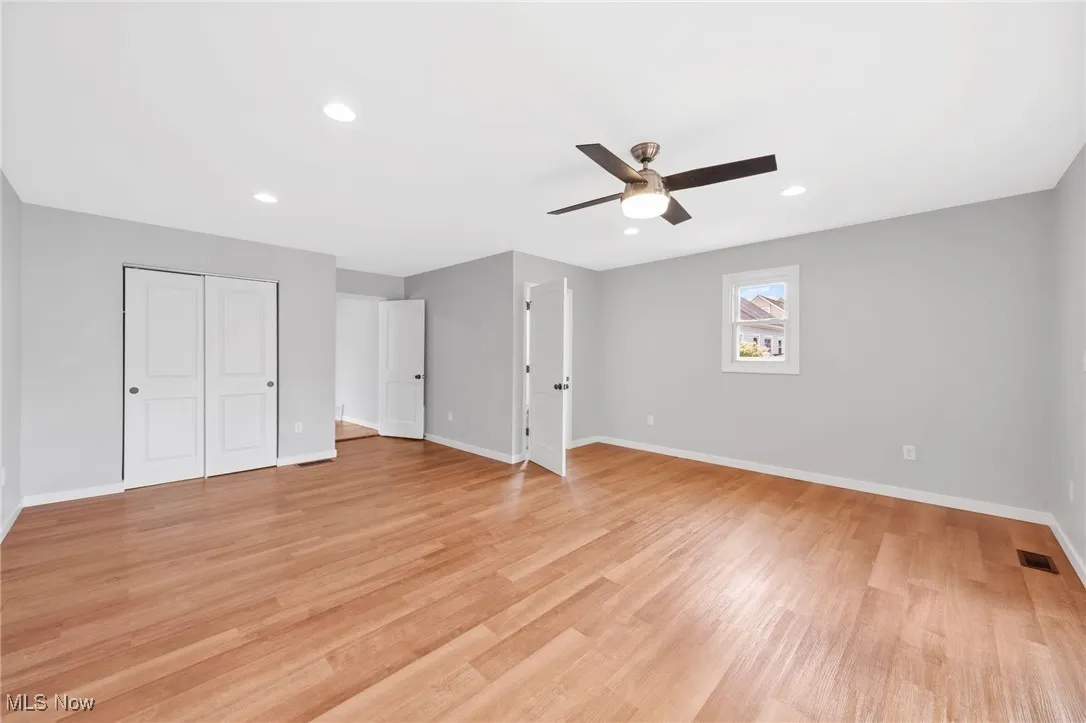 Unfurnished bedroom featuring light wood finished floors, a closet, recessed lighting, and a ceiling fan