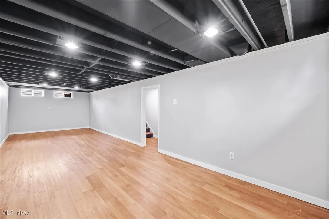 Below grade area with wood finished floors and stairway