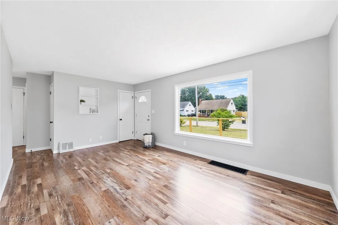 Unfurnished living room with wood finished floors