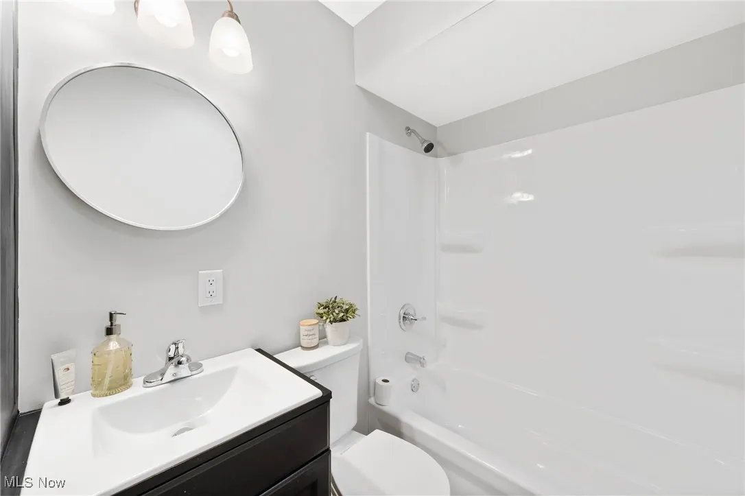 Bathroom with shower / tub combination and vanity