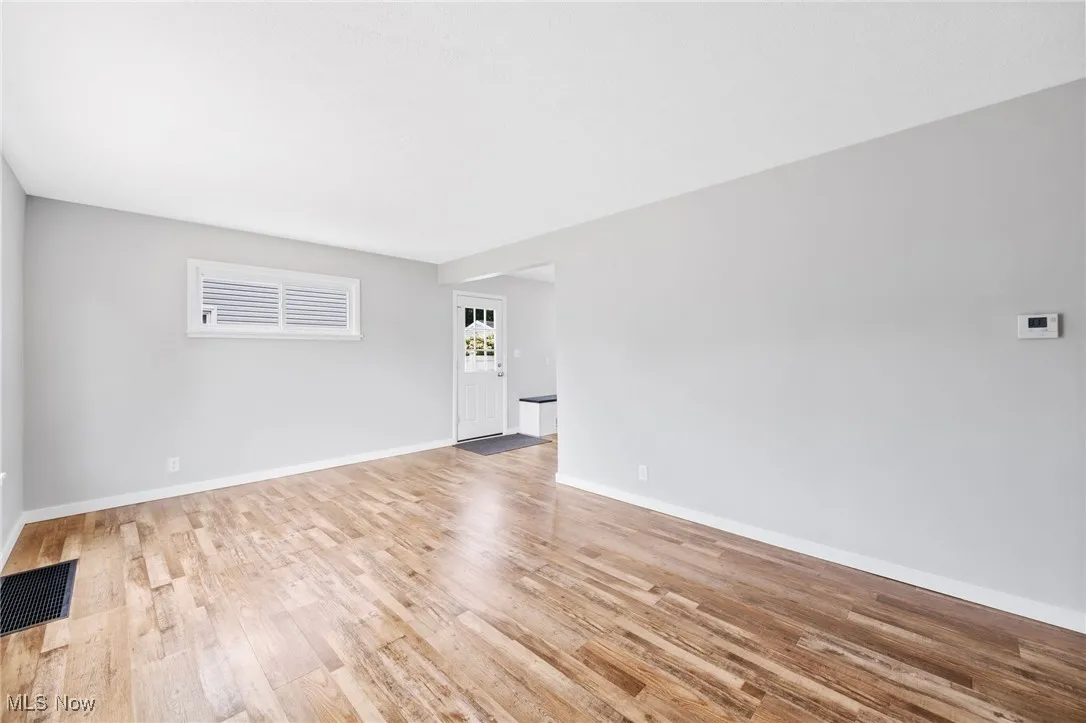 Spare room with light wood-style flooring and baseboards