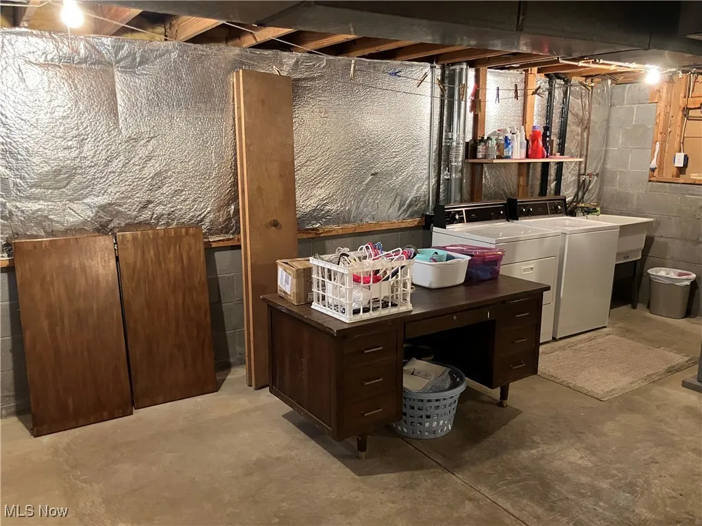 Unfinished below grade area featuring independent washer and dryer