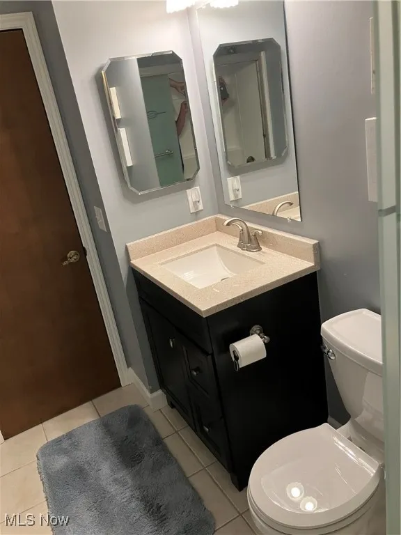 Bathroom featuring tile patterned flooring and vanity