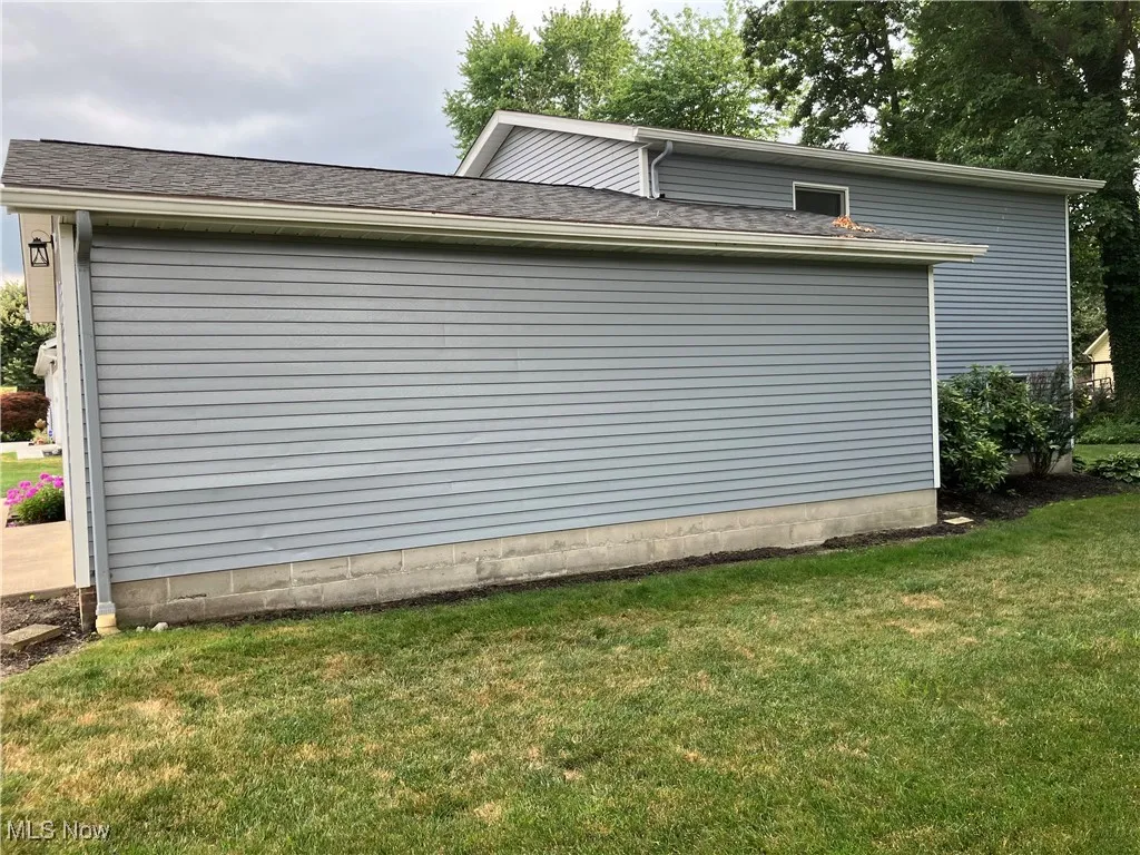 View of home's exterior featuring a yard