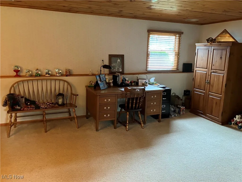 Office area featuring wooden ceiling and light colored carpet