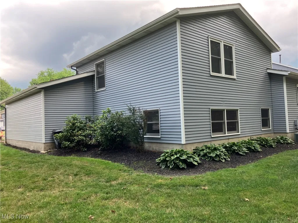 View of home's exterior with a lawn