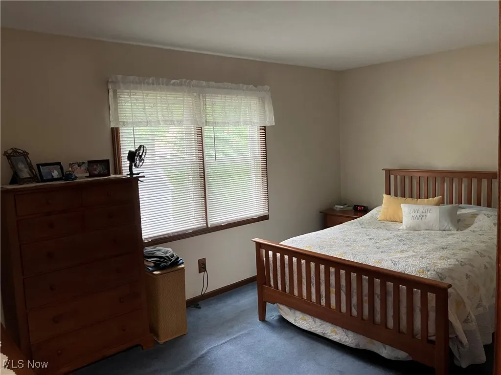 Carpeted bedroom with baseboards