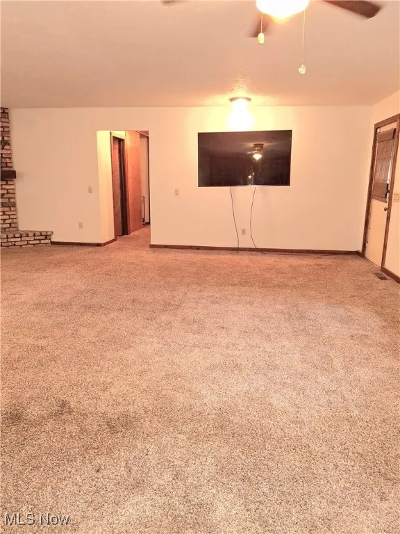Carpeted spare room with baseboards