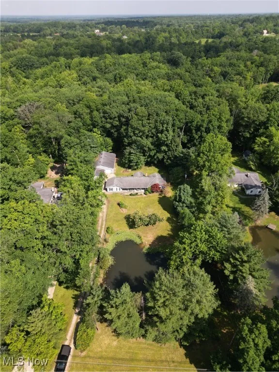 View of property location featuring a forest and a large body of water
