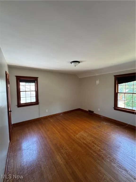 Bedroom 2 featuring dark wood-type flooring and plenty of natural light