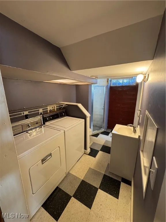 Laundry area featuring washing machine and dryer and light flooring