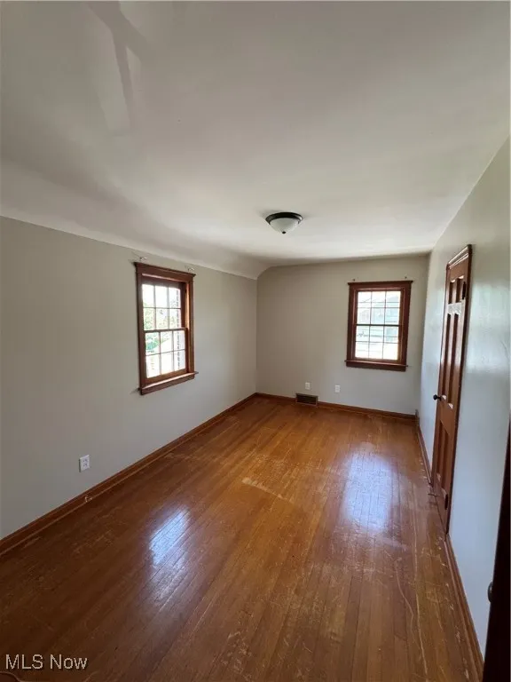 Bedroom 1 with plenty of natural light and hardwood / wood-style floors
