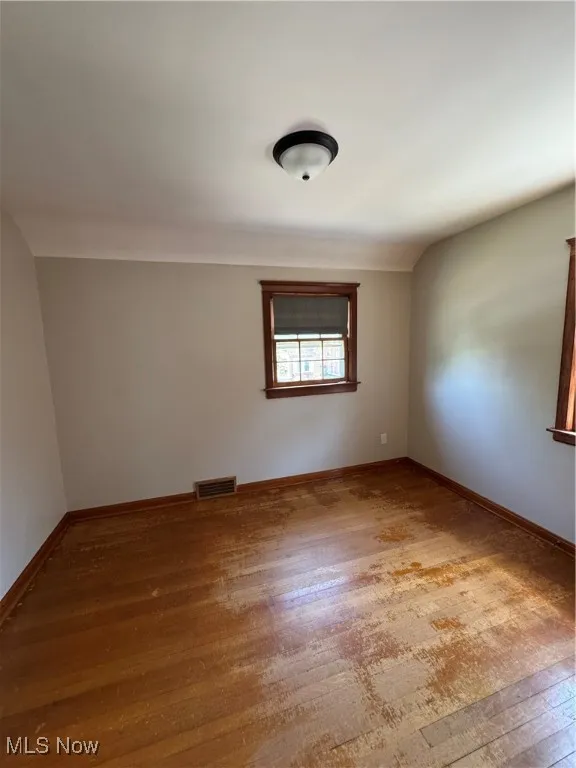 Bedroom 3 featuring wood finished floors and baseboards