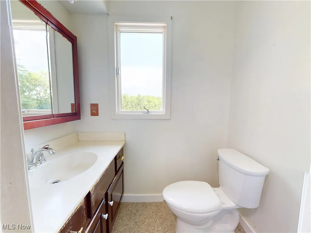 Half bathroom with vanity and toilet