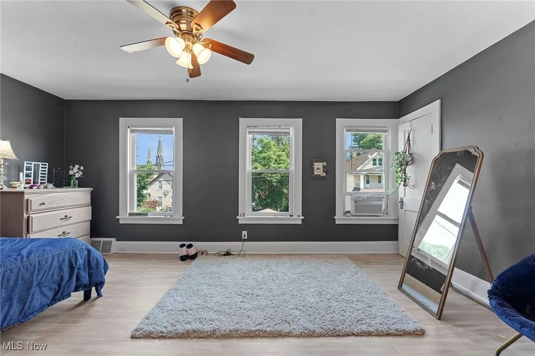 Bedroom featuring wood finished floors and a ceiling fan