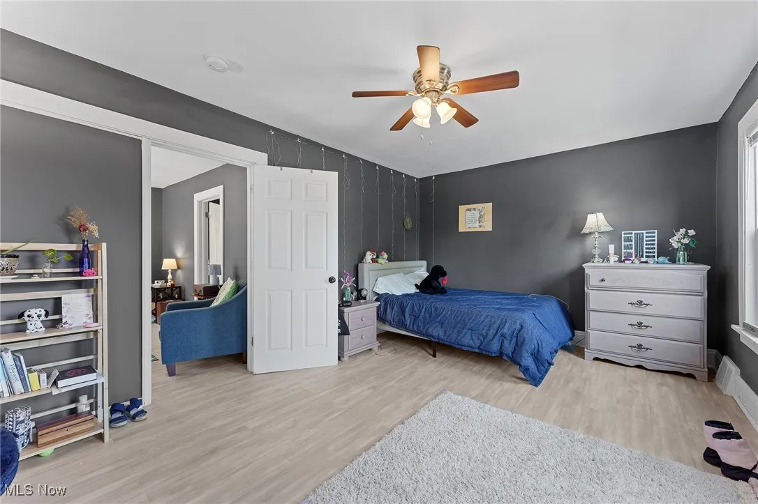 Bedroom featuring wood finished floors and ceiling fan