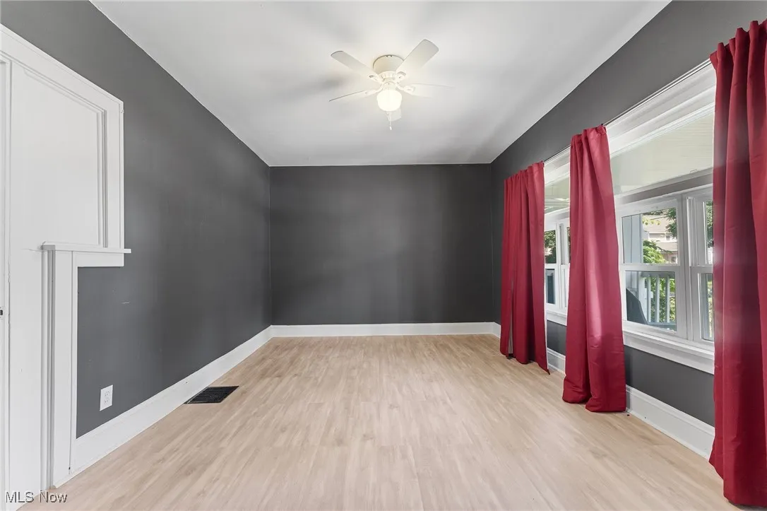 Empty room featuring wood finished floors and ceiling fan