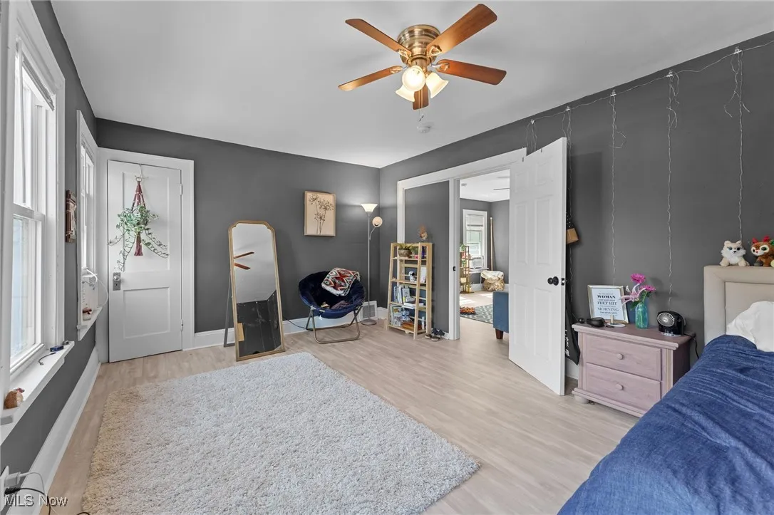 Bedroom with light wood-style floors and ceiling fan