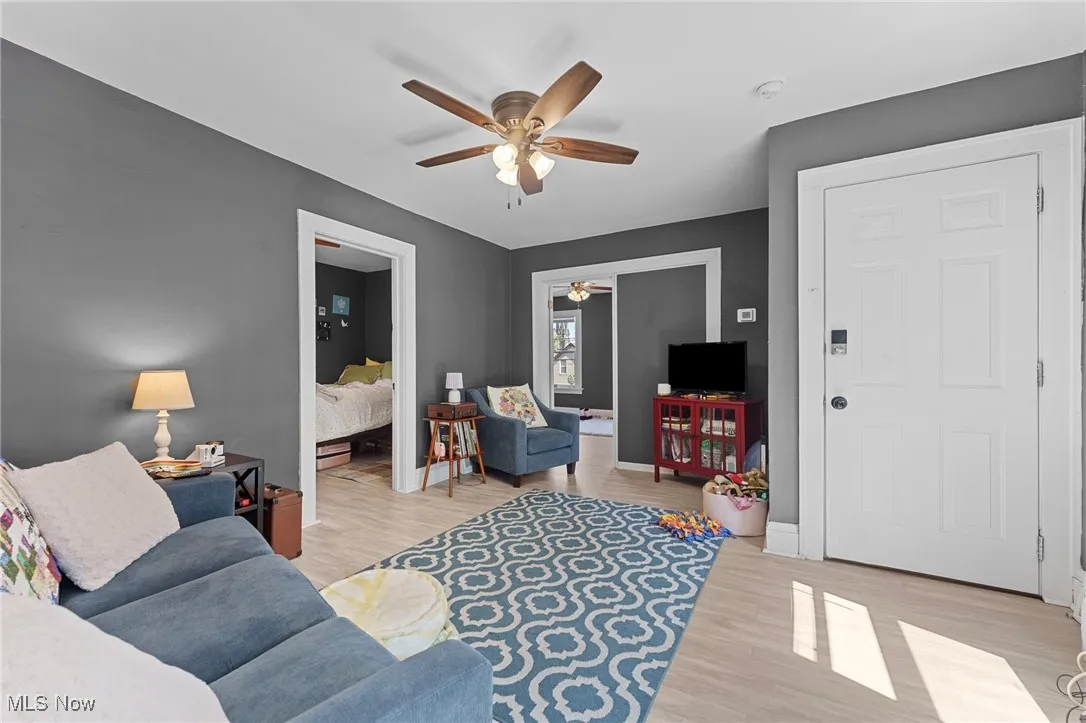 Living area featuring ceiling fan and light wood-style floors