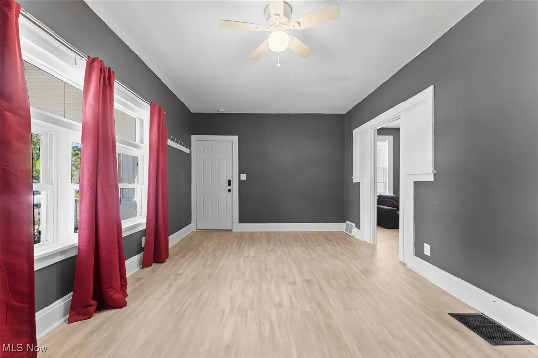 Spare room with a ceiling fan and wood finished floors