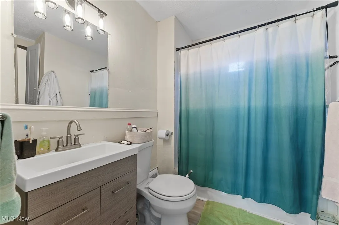 Full bath featuring vanity and toilet