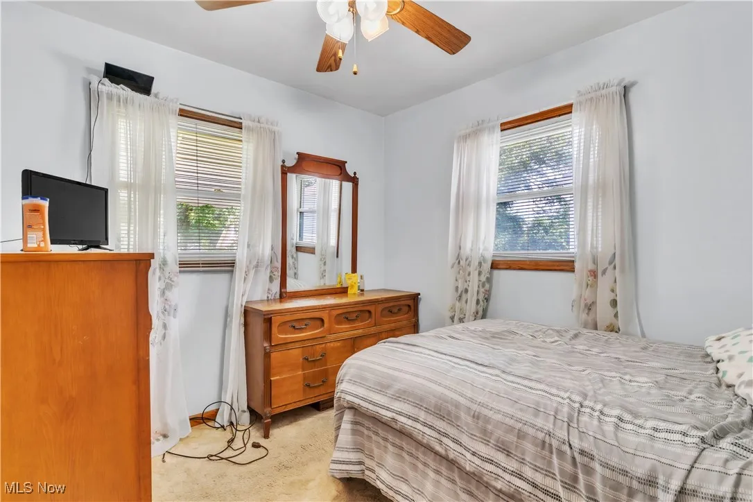 Bedroom featuring light carpet and ceiling fan