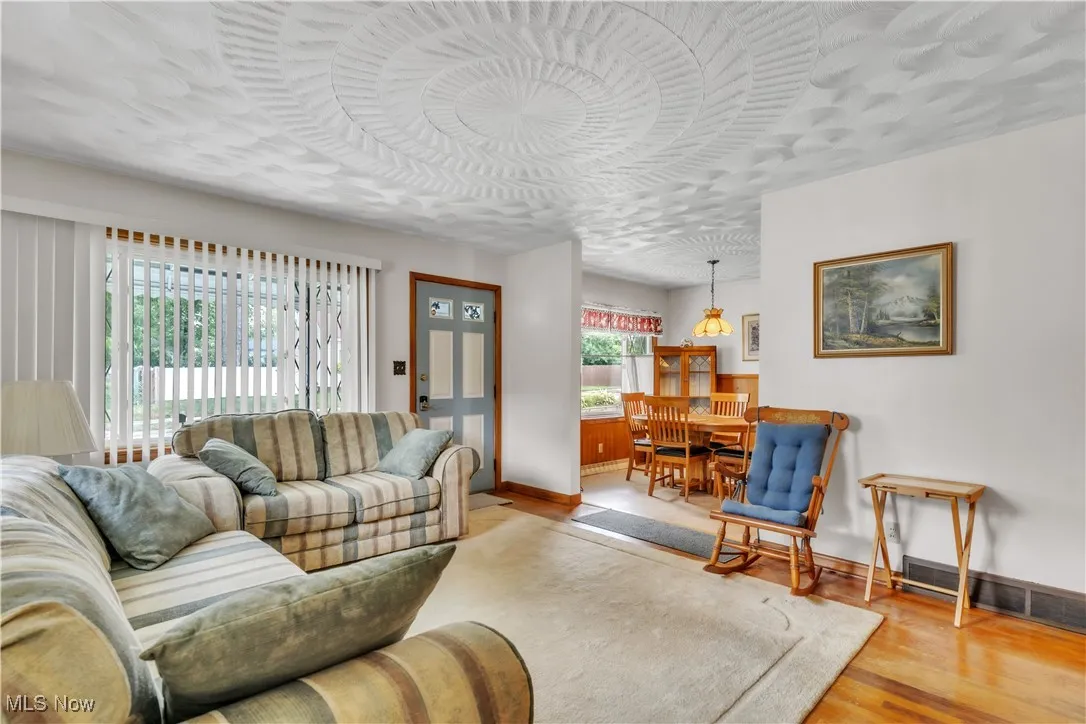 Living area with baseboards and wood finished floors