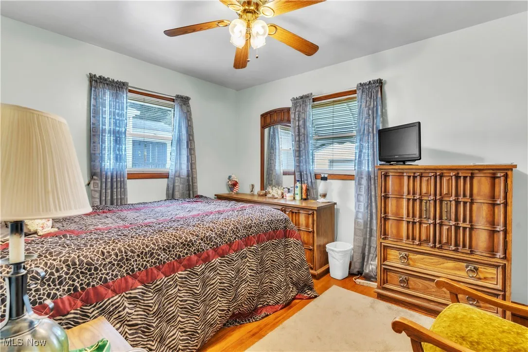 Bedroom featuring wood finished floors and a ceiling fan