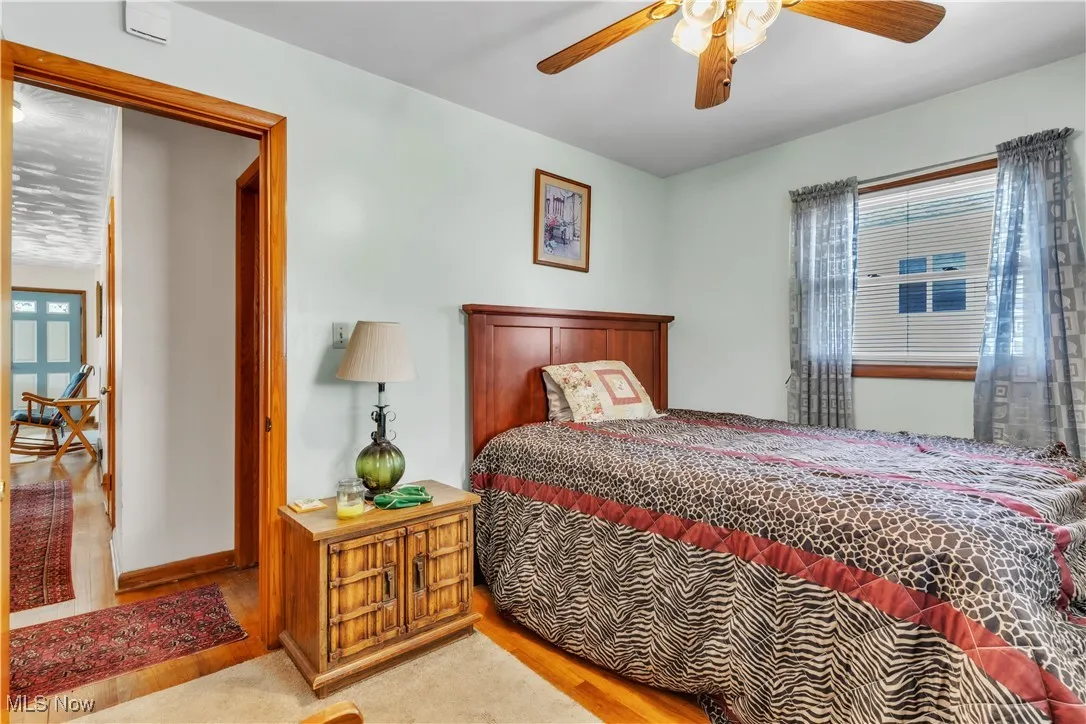 Bedroom with wood finished floors and ceiling fan